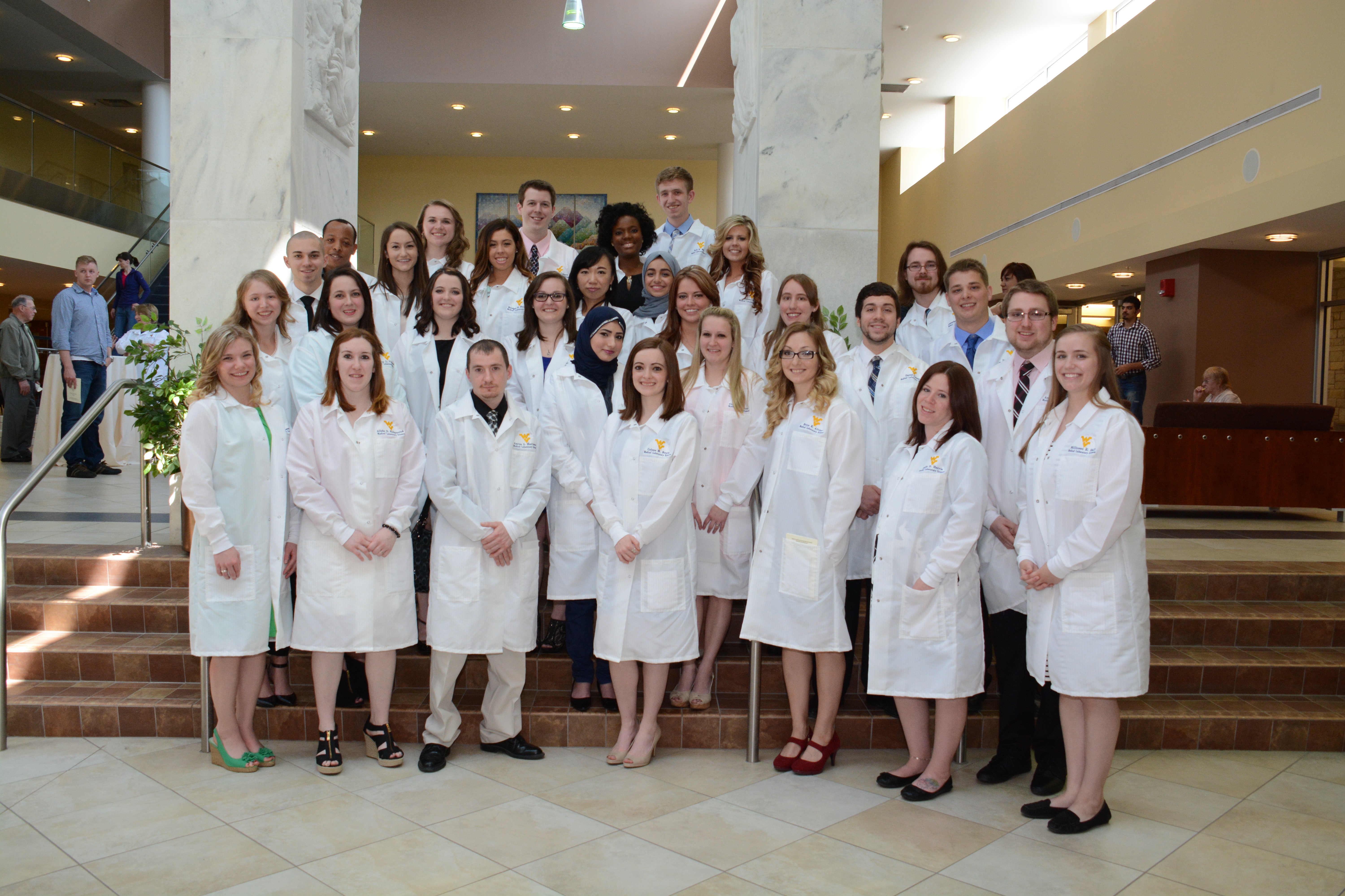 MLS students display their white coats after ceremony